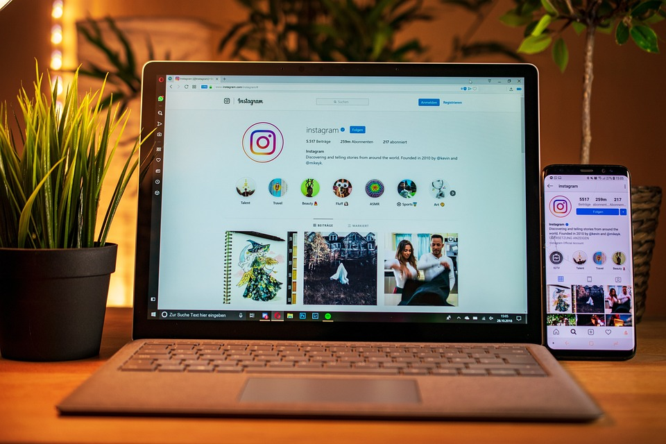 Instagram opened on phone and laptop